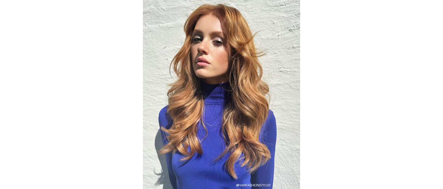 Woman with vibrant copper hair showcasing transitional spring hair color trend.